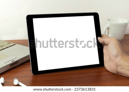Hands holding black tablet, isolated on white background,  business using digital tablet, close up hands multitasking man using tablet, laptop and cellphone connecting, Young smart busy professional b