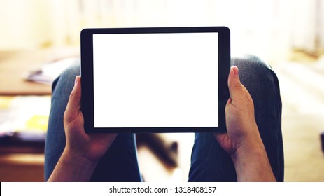 hands holding black Tablet mobile phone device with white empty mockup blank screen, copy space background. - Shutterstock ID 1318408157