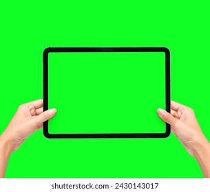 Hands Holding Black Tablet Pad green screen with black tablet computer, isolated on green screen background. Watching screen on Gadget presentation Mockup. - Powered by Shutterstock