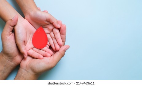 Hands holding blood drop, give blood donation, blood transfusion, world blood donor day, world hemophilia day concept