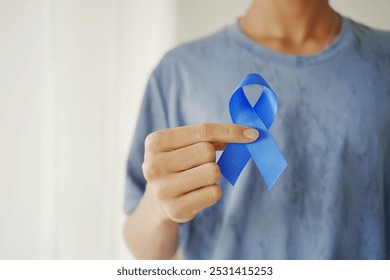 Hands holding blue ribbon, Prostate cancer awareness, November blue, men health awareness - Powered by Shutterstock