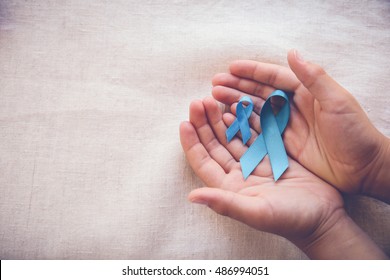 hands holding blue ribbons,Prostate Cancer Awareness, Men's health care concept, movember November blue, world diabetes day - Powered by Shutterstock