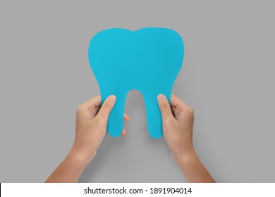 Hands Holding Blue Tooth Isolated.  Teeth Care And Protection Concept. 