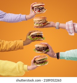 Hands holding burgers on the orange background. Burger with juicy marbled beef patty, freshly baked bun, fresh farm vegetables, melting cheese and signature sauce. - Shutterstock ID 2189352263
