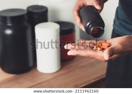 Hands holding capsules of supplement with copy space healthy life.