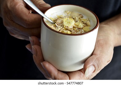 Hands Holding Cereals Flake With Oats And Yogurt In Cup