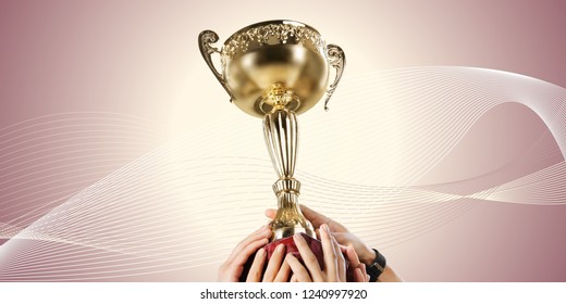 Hands holding a champion golden trophy on white background