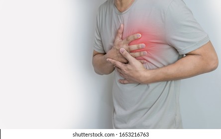 Hands holding chest with symptom heart attack disease - Shutterstock ID 1653216763