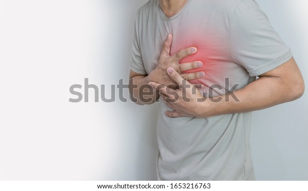 Hands\
holding chest with symptom heart attack\
disease