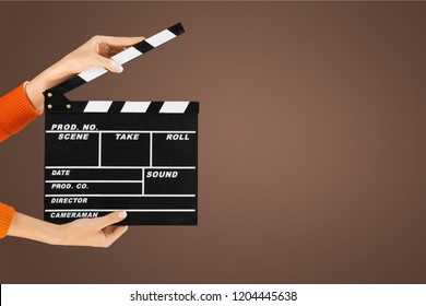 Hands holding clapper board