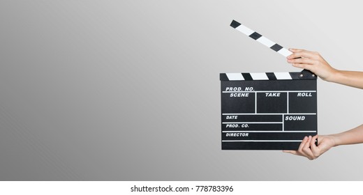 Hands holding clapper board