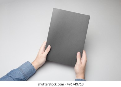Hands holding closed Notebook. Blank cover Mock-up.