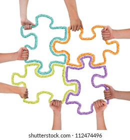 Hands Holding Colorful Puzzle Pieces