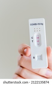 Hands Holding Covid-19 Rapid Antigen Test Cassette With Positive Result Of Rapid Diagnostic Test At Home