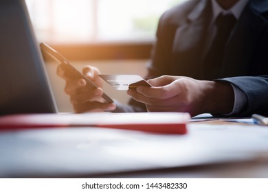 Hands holding credit card and using laptop and smart phone. Online shopping. Online payments concept. - Shutterstock ID 1443482330