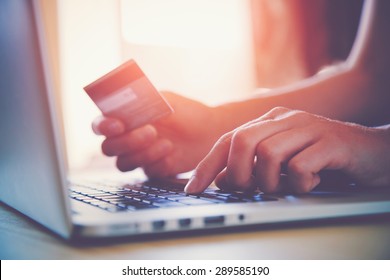 Hands holding credit card and using laptop. Online shopping - Shutterstock ID 289585190