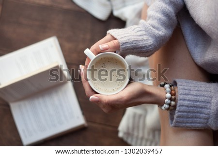 hands holding a Cup of coffee. Bracelets.