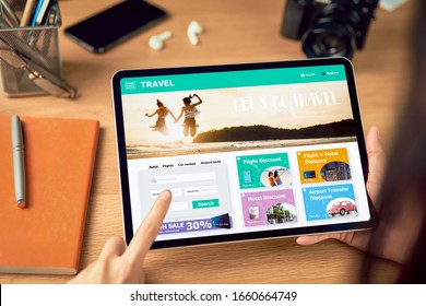 Hands holding digital tablet with application booking flight travel search ticket holiday and hotel on website discounted price, concept technology online marketing and promotion. - Powered by Shutterstock