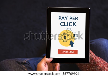 Hands holding digital tablet computer with Pay Per Click (PPC) concept on screen. All screen content is designed by me. View from above.