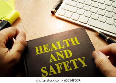 Hands Holding Documents With Title Health And Safety.