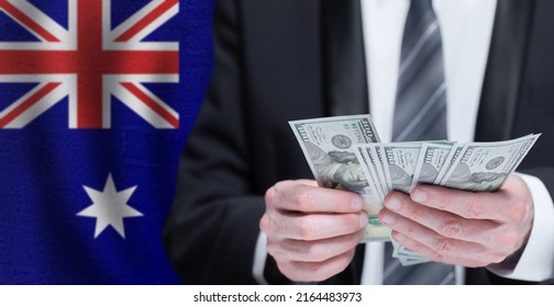 Hands Holding Dollar Money On Flag Of Australia