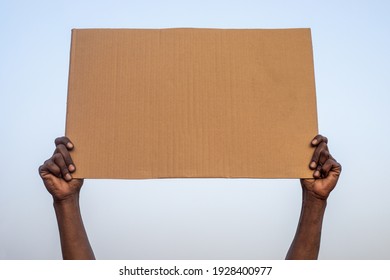 Hands Holding Empty Piece Of Cardboard