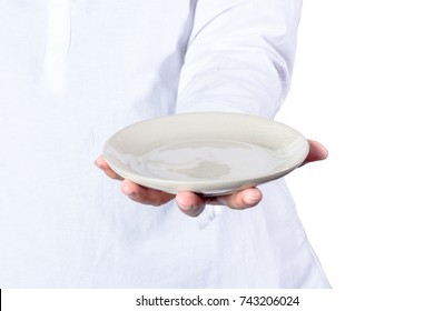 Hands holding empty plates in front of white background.