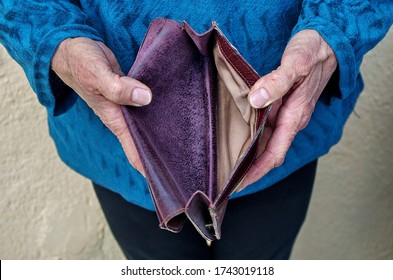 Hands Holding Empty Wallet. The Concept Of Poverty, Retirement. No Money, Help Me.  