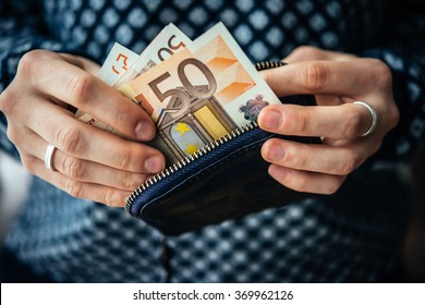 Hands Holding Euro Bills And Small Money Pouch