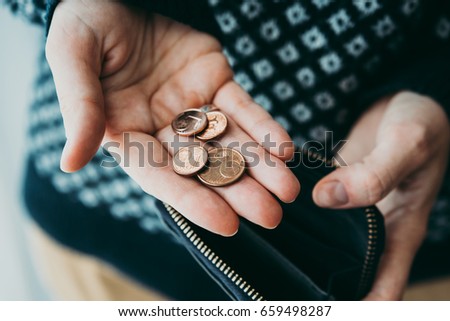 Hands holding euro cent coins and small money pouch