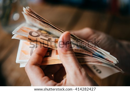 Hands holding european Euro bills