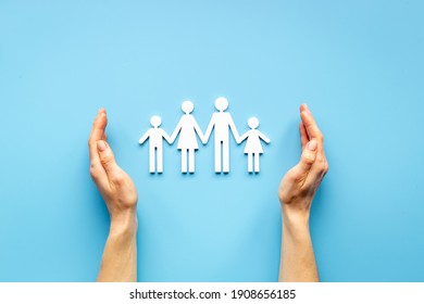 Hands holding family figure top view. Insurance concept - Shutterstock ID 1908656185