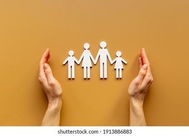 Hands holding family figure top view. Insurance concept - Shutterstock ID 1913886883