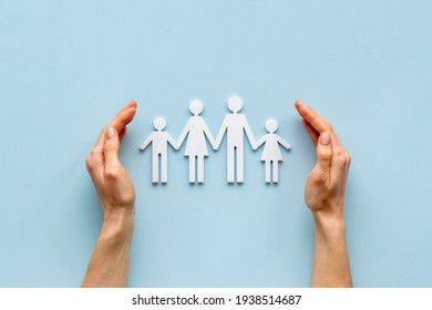 Hands holding family figure top view. Insurance concept - Shutterstock ID 1938514687