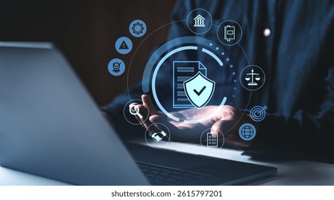 Hands holding floating cybersecurity icons, digital style, above laptop on dark background, symbolizing secure data and compliance systems
