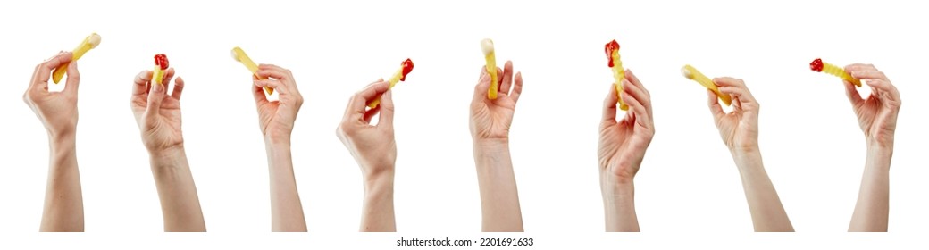 The hands holding the French fries with ketchup and white sauce in front of the white background - Powered by Shutterstock