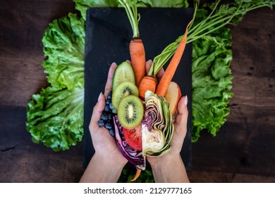 Woman’s Hands Holding Fresh Produce And Fruits