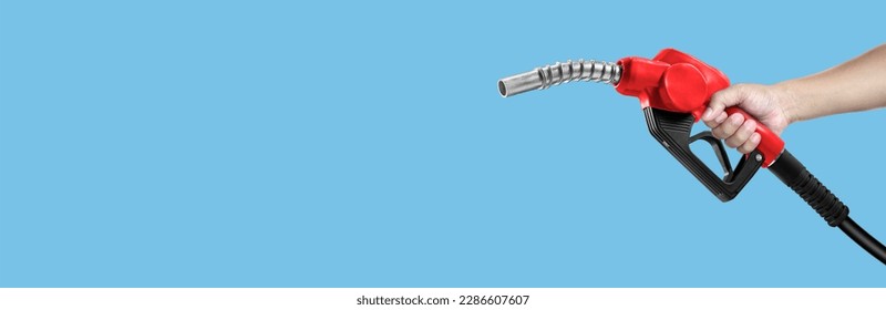 Hands holding Fuel nozzle on light blue background