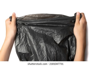 Hands holding garbage bag isolated. Trash package roll, new rolled plastic bin bags, black polyethylene waste container on white background - Shutterstock ID 2181047731