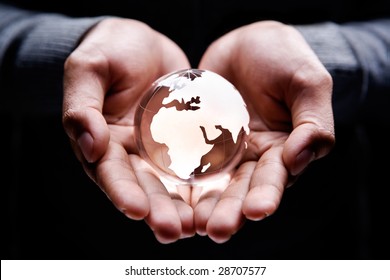 Hands Holding A Glass Globe Showing Africa, Europe And Part Of Middle East