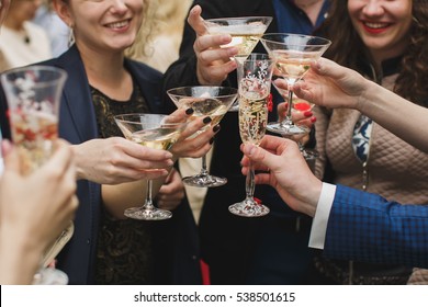 Hands holding glasses and toasting, happy festive moment, luxury celebration concept. Clinking glasses of champagne in hands