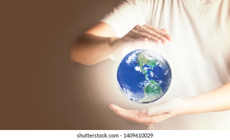 Hands Holding glowing global Earth, World in our hands, Love and care for our earth concept, , Elements of this image furnished by NASA - Shutterstock ID 1409610029