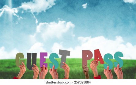 Hands Holding Up Guest Pass Against Blue Sky Over Green Field