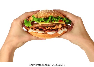 Hands holding a hamburger with lettuce, cheese and bacon on white background. Fast food.