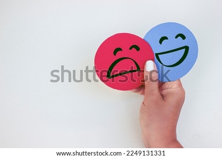Hands holding happy and sad paper face, feedback, rating, positive customer survey, mood swing, mental health assessment, bipolar disorder concept