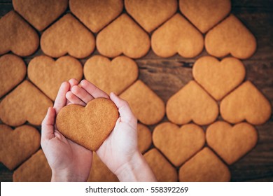 Hands Holding Heart Cookies 