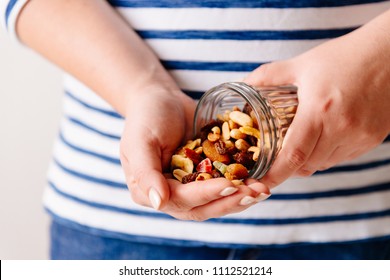 Hands holding a jar of nuts and dried fruits. Healthy breakfast. Sweet and healthy food, snack - Powered by Shutterstock