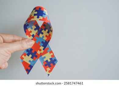 hands holding jigsaw puzzle ribbon, Autism awareness,Autism spectrum disorder family support concept, World Autism Awareness Day
 - Powered by Shutterstock - Get 15% off with code: PIKWIZARD15