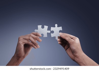 Hands holding jigsaw puzzles, business matching concept