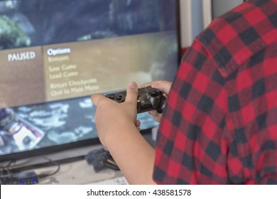Hands Holding a Joystick Controller while playing a video games at home